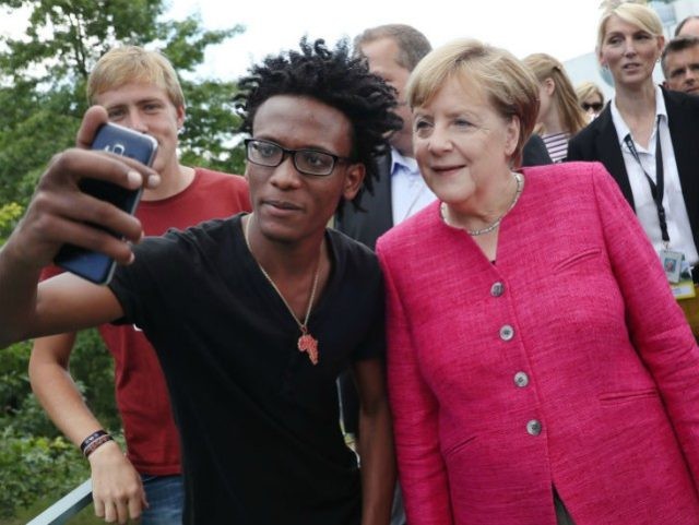 BERLIN, GERMANY - AUGUST 27: German Chancellor Angela Merkel pauses for a selfie with a yo