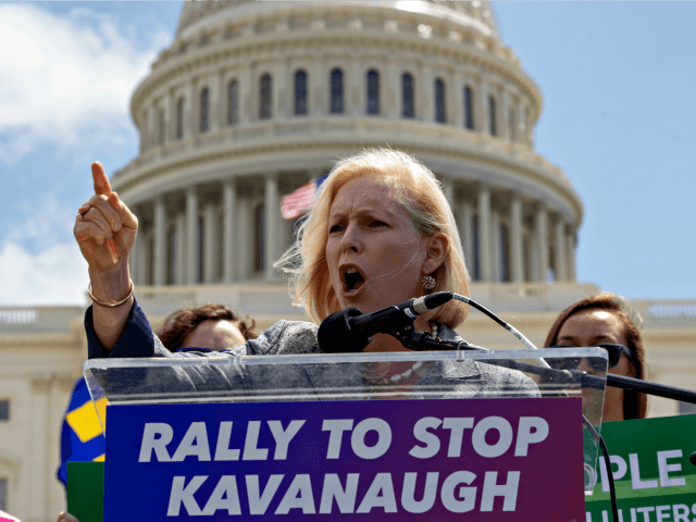 Sen. Kirsten Gillibrand, D-N.Y., joins protesters objecting to President Donald Trump's Supreme Court nominee Brett Kavanaugh, at a rally Capitol in Washington, Wednesday, Aug. 1, 2018.
