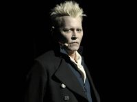 JOhnnyDepppulled1 Johnny Depp appears in character as Gellert Grindelwald at the Warner Bros. Theatrical panel for "Fantastic Beasts: The Crimes of Grindelwald" on day three of Comic-Con International on Saturday, July 21, 2018, in San Diego. (Photo by Chris Pizzello/Invision/AP)