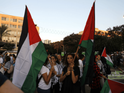 Arab Israelis carry Palestinian flags during a demonstration to protest against the 'Jewish Nation-State Law' in the Israeli coastal city of Tel Aviv on August 11, 2018. - The controversial law passed last month declaring the country the nation state of the Jewish people. This has led to concerns that …