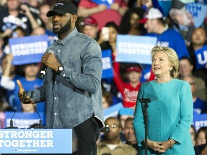 Democratic presidential candidate Hillary Clinton applauds Cleveland Cavaliers star LeBron