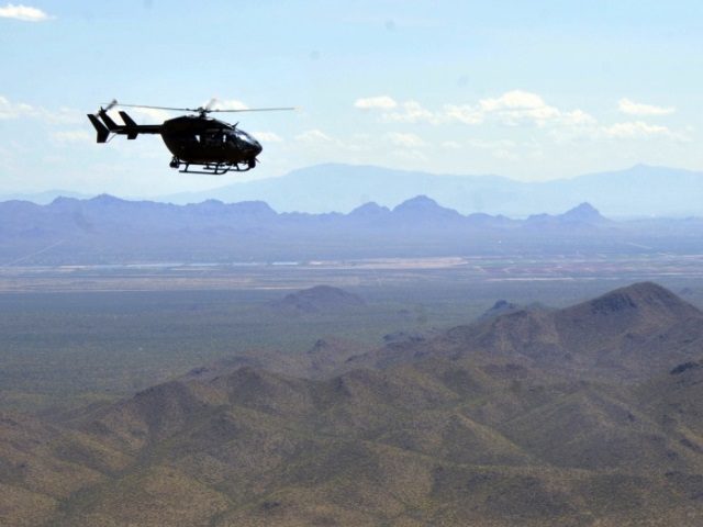 National Guard Lakota LUH-72 helicopter patrols over Arizona mountains (National Guard Fil