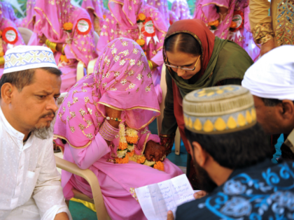 An Indian Muslim bride (C) answers questions by religious leaders during the 'Nikah Kabool