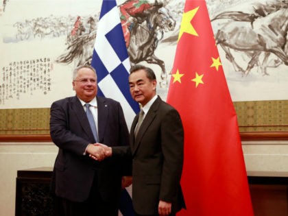 Greece's Foreign Minister Nikos Kotzias (L) is greeted by his Chinese counterpart Wang Yi during their meeting at the Diaoyutai State House in Beijing on August 27, 2018. (Photo by HOW HWEE YOUNG / POOL / AFP) (Photo credit should read HOW HWEE YOUNG/AFP/Getty Images)