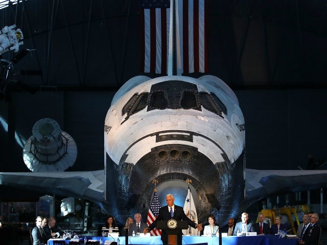 The Space Shuttle Discovery is the back drop as Vice President Mike Pence speaks during th