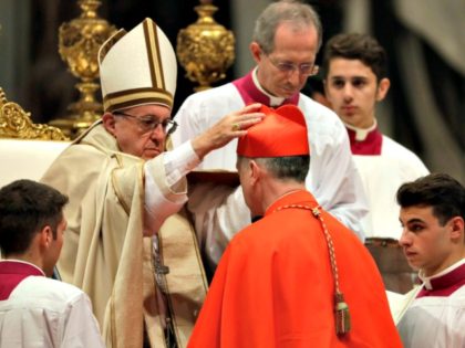 New Cardinal Blase Cupich receives the red three-cornered biretta hat during a consistory