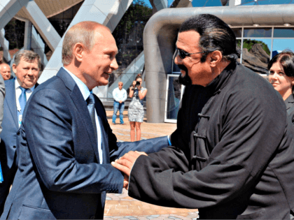 Russian President Vladimir Putin, left, and U.S. actor Steven Seagal shake hands after visiting an oceanarium built on Russky Island, where the Eastern Economic Forum takes place, in Russian Far Eastern port of Vladivostok, Russia, Friday, Sept. 4, 2015.