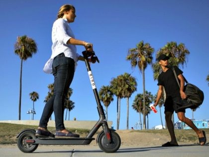 https://media.gettyimages.com/photos/woman-rides-a-bird-shared-dockless-electric-scooter-a