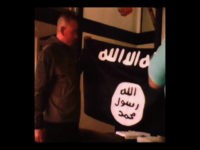 In this image taken from FBI video and provided by the U.S. Attorney's Office in Hawaii on Thursday, July 13, 2017, Army Sgt. 1st Class Ikaika Kang holds an Islamic State group flag after allegedly pledging allegiance to the group at a house in Honolulu on July 8. (FBI/U.S Attorney's …