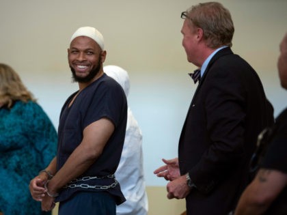 Siraj Wahhaj laughs in court, Monday, Aug. 13, 2018, in Taos, N.M. Wahhaj was among several people arrested after authorities raided a property and found 11 children living on a squalid compound on the outskirts of tiny Amalia, N.M., a week earlier. (Roberto E. Rosales/The Albuquerque Journal via AP, Pool)