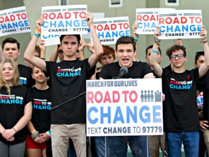 Cameron Kasky, center, speaks during a news conference, Monday, June 4, 2018, in Parkland, Fla. A day after graduating from high school, a group of Florida school shooting survivors has announced a multistate bus tour to "get young people educated, registered and motivated to vote."