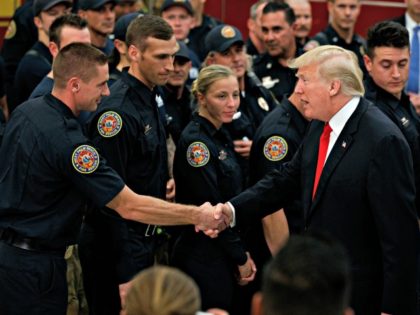 President Donald Trump shakes hands with firefighters at West Palm Beach Fire Rescue, Wednesday, Dec. 27, 2017, in West Palm Beach, Fla. President Trump who is spending the holidays at his private Mar-a-Lago estate and club in Florida thanked them for their service.