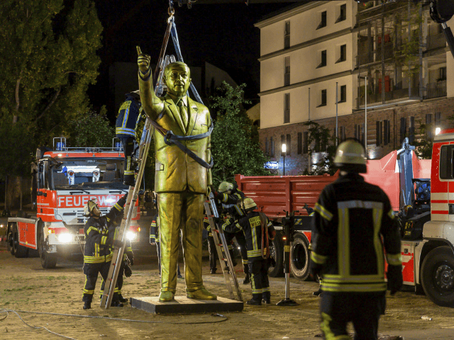 In this Aug. 28, 2018 photo a crane of the firebrigade lifts a statue of Turkish President