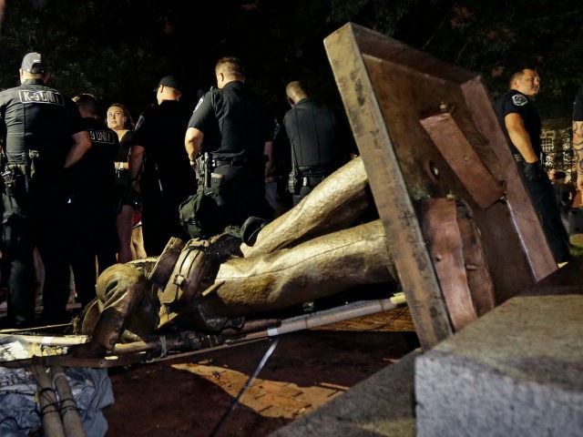 olice stand guard after the confederate statue known as Silent Sam was toppled by protesters on campus at the University of North Carolina in Chapel Hill, N.C., Monday, Aug. 20, 2018. (AP Photo/Gerry Broome)