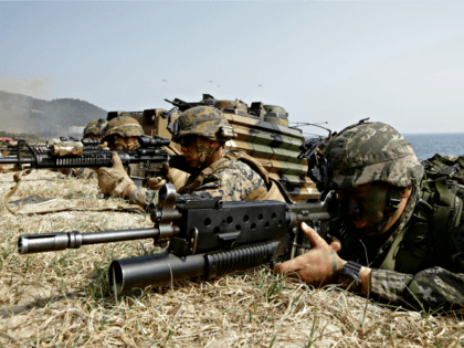 In this March 30, 2015, file photo, marines of South Korea, right, and the U.S aim their weapons near amphibious assault vehicles during U.S.-South Korea joint landing military exercises as part of the annual joint military exercise Foal Eagle between the two countries in Pohang, South Korea. U.S. President Donald …