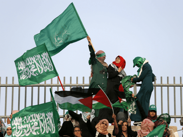 Arab-Israeli women wave Islamic and Palestinian flags during a rally organized by the Isla