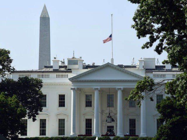 The flag of the United States flies at half-staff over the White House in Washington, Tues