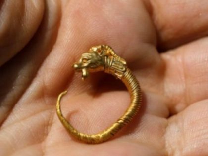 AFP | An Israeli archaeologist shows a golden earring believed to be more than 2,000 years old discovered at the site of a national park in annexed east Jerusalem near the Old City walls