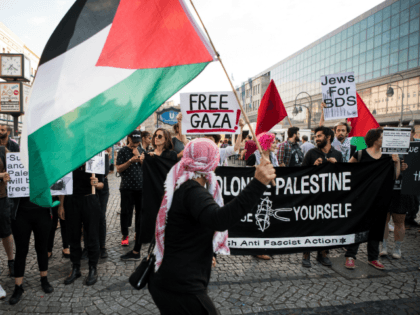 People wave Palestinian flags as they protest in in Berlin on May 14, 2018. - The United S