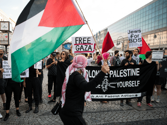 People wave Palestinian flags as they protest in in Berlin on May 14, 2018. - The United States moved its embassy in Israel to Jerusalem after months of global outcry, Palestinian anger and exuberant praise from Israelis over President Donald Trump's decision tossing aside decades of precedent. (Photo by Bernd …