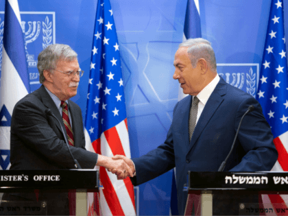 Israeli Prime Minister Benjamin Netanyahu (R) shakes hands with visiting US national security adviser John Bolton during a press conference at the Prime Minister's office in Jerusalem on August 20, 2018. - Bolton arrived in Israel on August 19 for talks with PM Benjamin Netanyahu at a time of shared …