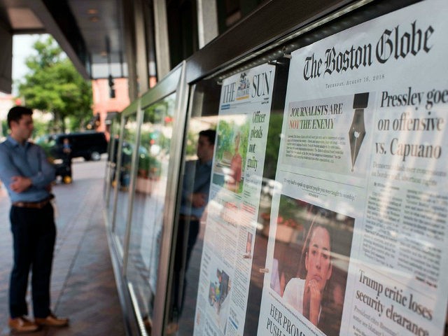 The front page of the Boston Globe August 16, 2018 edition is on display outside the Newse
