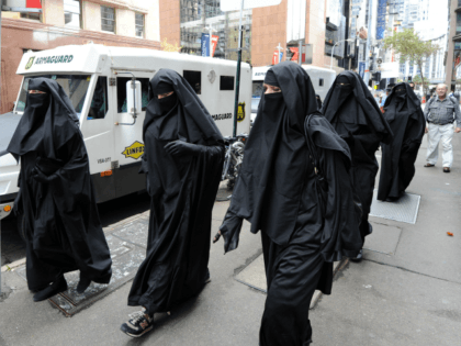 Men and women dressed in burqas from the group 'Faceless' call for the banning of the conservative Muslim apparel throughout Australia during a rally in Sydney on April 2, 2012. The group says the complete covering of a woman's face leads to cultural isolation within multi-cultural Australia and can be …