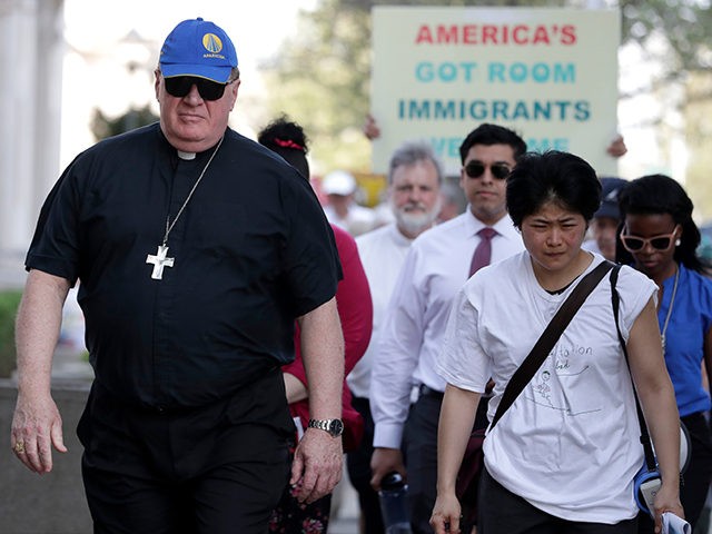 Newark Archbishop Cardinal Joseph Tobin, left, walks with activists outside of the Peter Rodino Federal Building during an immigration protest, Thursday, May 3, 2018, in Newark, N.J. (AP Photo/Julio Cortez)