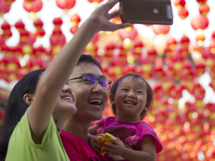 A Malaysian ethnic Chinese family take a selfie on the first day of Chinese Lunar New Year
