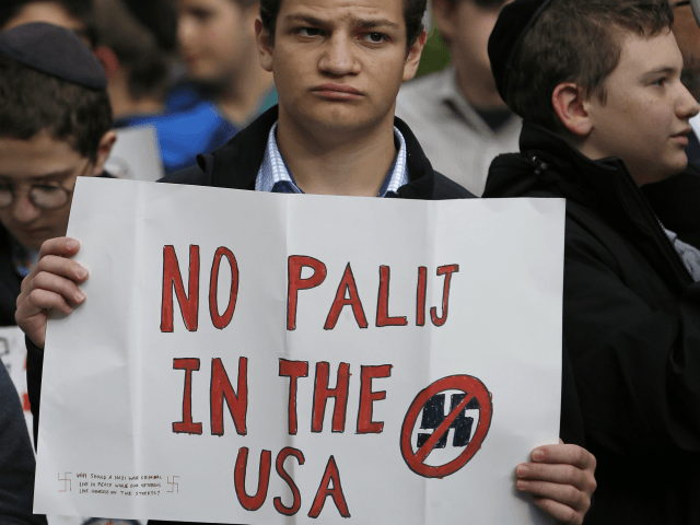 A student from the Rambam Mesivta high school holds a sign as he and his Orthodox Jewish s
