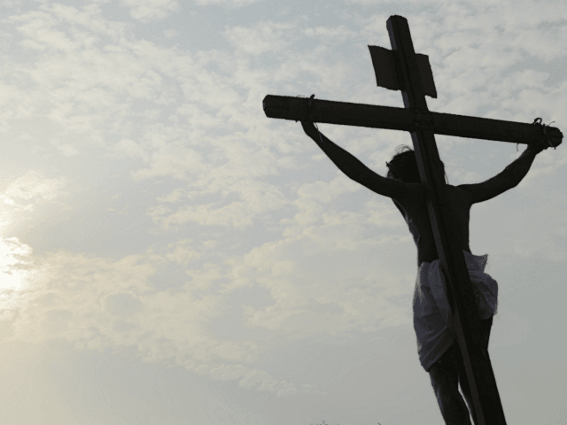 Indian Catholic devotees re-enact the crucifixion of Jesus Christ during a Passion play at