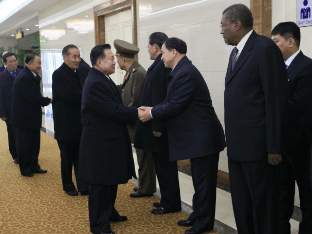 Choe Ryong Hae, center left, a vice chairman of North Korea's Workers' Party, shakes hands