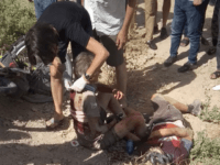 a woman helps a wounded cyclist, where the four tourists were killed when a car rammed into a group of foreigners on bicycles south of the capital of Dushanbe, Tajikistan. The Islamic State group on Tuesday claimed responsibility for a car-and-knife attack on Western tourists cycling in Tajikistan that killed …