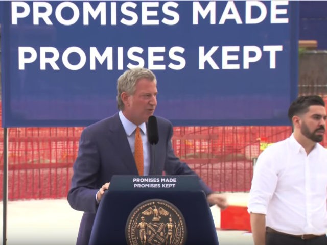 New York Mayor Bill de Blasio's “promises made, promises kept” sign at a school ground
