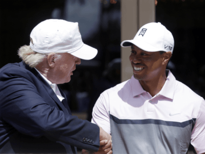 Donald Trump, left, shakes hands with Tiger Woods during a ribbon cutting for the new Tige