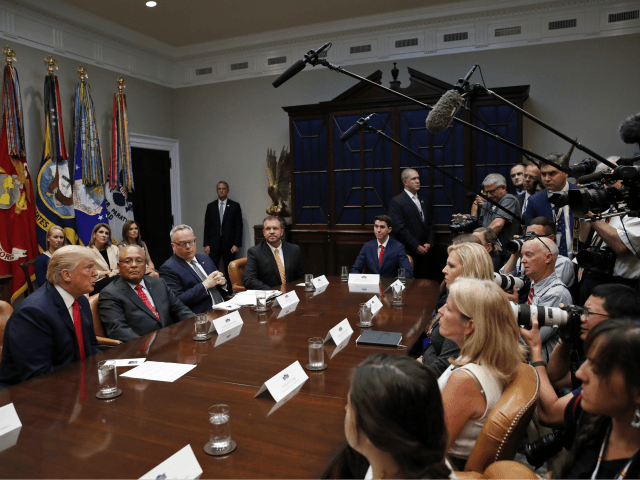 President Donald Trump, left, answers questions from the media during a discussion for drug-free communities support programs, in the Roosevelt Room of the White House, Wednesday, Aug. 29, 2018, in Washington. (AP Photo/Alex Brandon)