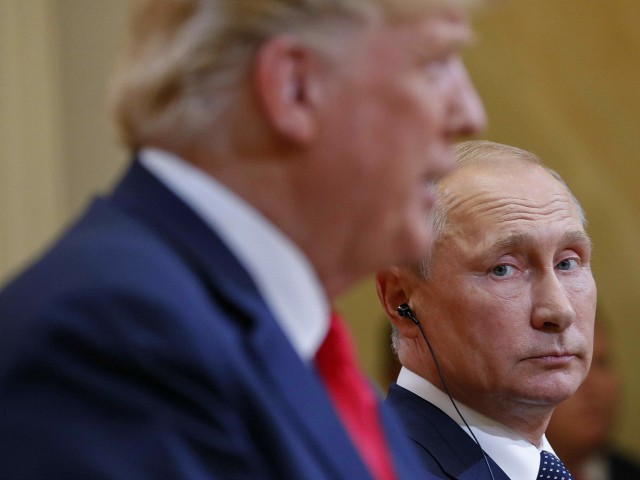 Russian President Vladimir Putin, right, looks over towards U.S. President Donald Trump, left, as Trump speaks during their joint news conference at the Presidential Palace in Helsinki, Finland, Monday, July 16, 2018. (AP Photo/Pablo Martinez Monsivais)