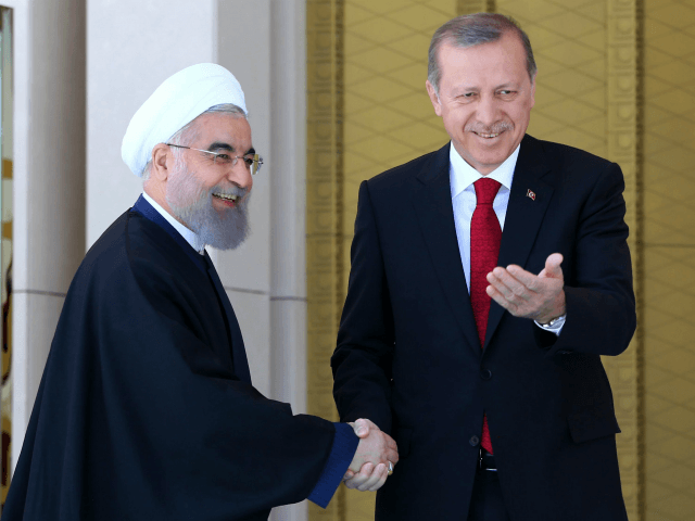 Turkish President Recep Tayyip Erdogan (R) shakes hands with his Iranian counterpart Hassan Rouhani during an official welcoming ceremony at the presidential complex in Ankara on April 16, 2016. / AFP / ADEM ALTAN (Photo credit should read ADEM ALTAN/AFP/Getty Images)