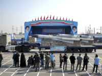 In front of the portraits of supreme leader Ayatollah Ali Khamenei, right, and the late revolutionary founder Ayatollah Khomeini, left, a missile is displayed by Iran's army during a parade marking National Army Day at the mausoleum of Khomeini, just outside Tehran, Iran, Wednesday, April 18, 2018. (AP Photo/Ebrahim Noroozi)