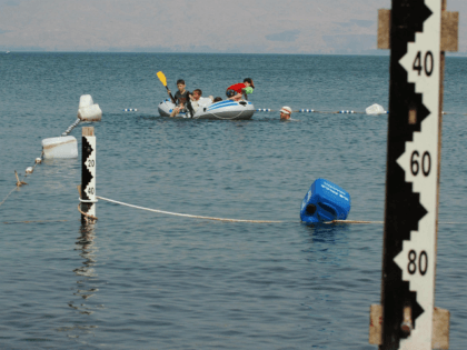Israel children play on August 24, 2008 on a boat near water measurement scales at the Sea of Galilee in northern Israel, which has seen a big decrease of its water level. The Jordan River supplies 95% of the water in the Sea of Galilee sweet lake. After four consecutive …