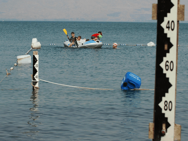 Israel children play on August 24, 2008 on a boat near water measurement scales at the Sea