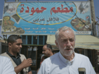 jeremy corbyn United Kingdom's Labour party leader Jeremy Corbyn walks in the main market road during his visit to the Zaatari Syrian Refugee Camp, in Mafraq, Jordan, Friday, June 22, 2018. Arabic in background reads "Hamoudah restaurant, Arabic Falafel." (AP Photo/Nasser Nasser)