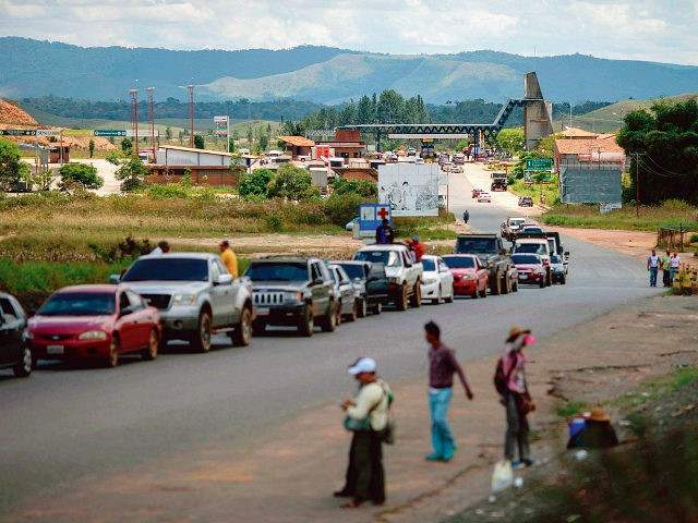 View of cars in line and the Venezuelan Immigration Point (on the background) from the bor