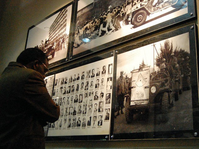 Visitors look at pictures on March 7, 2010 of victims of Ethiopia's 'Red Terror' campaign during the inauguration of the museum on March 7, 2010 in Addis Ababa. The museum took three years to complete and honours the dead with photographs of the 1977-78 campaign of state terror by former …