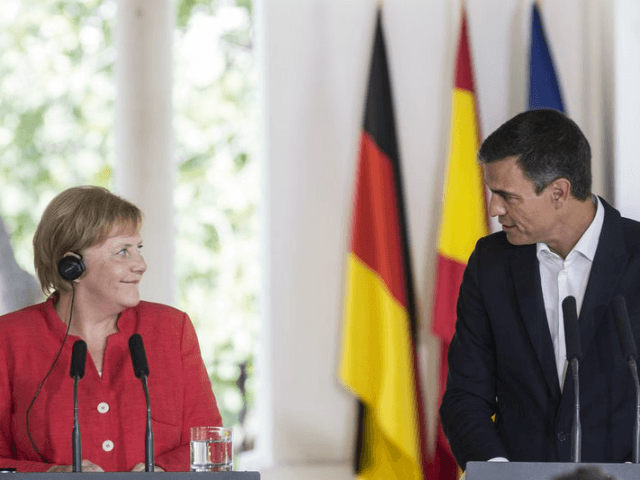 German Chancellor Angela Merkel, left and Spanish Prime Minister Pedro Sanchez begin a joi