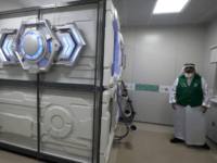nap pod Mansour al-Amer, head of Saudi charity the Haji and Mutamer Gift Charitable Association, stands next to sleep pods in Mecca on August 16, 2018. - The free nap pods are part of new measures Saudi Arabia is rolling out this year in a bid to modernise the centuries-old practice of …