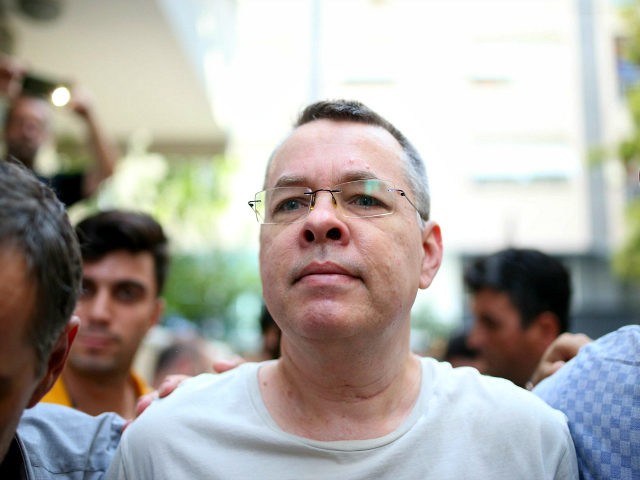 Pastor Andrew Craig Brunson (R), escorted by Turkish plain clothes police officers as he a