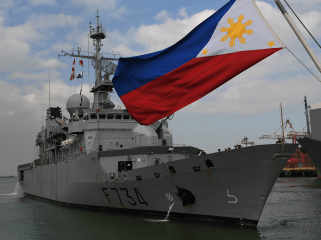 French navy frigate Vendemiaire prepares to dock while a Philippine flag flutters at the i