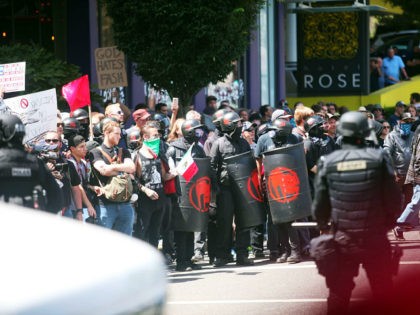 Alt-right activists, anti-fascist protestors, and people on all sides of the political spectrum gather for a campaign rally organized by right-wing organizer, Patriot Prayer founder and Republican Senate candidate Joey Gibson in Portland, Oregon, August 4, 2018. - Police in Portland braced for violence at the rally that has raised …