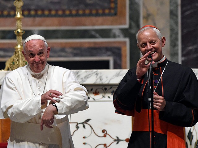 Cardinal Donald Wuerl, archbishop of Washington, right, translates for Pope Francis as the